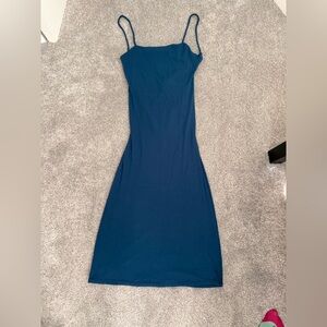 Blue midi dress with spaghetti straps and open back tie detail.
